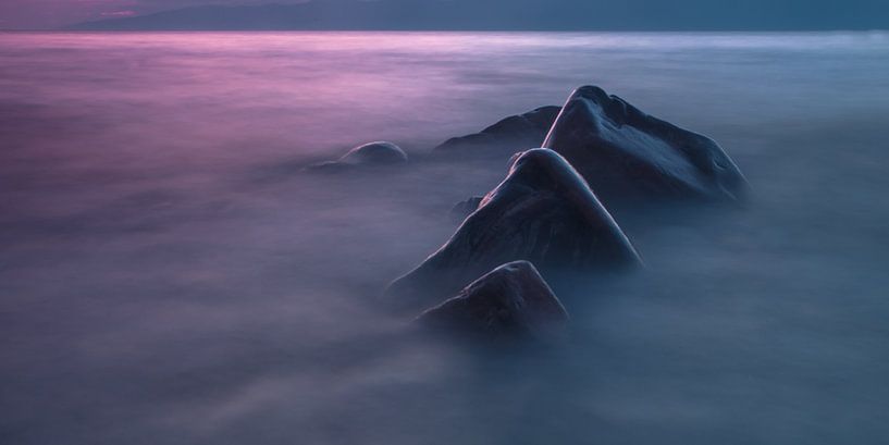 Three stones in the water resembling clouds on another planet, titanium. Long exposure by Michael Semenov