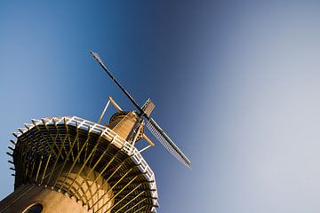Mill against a clear blue sky by Pieter van Roijen