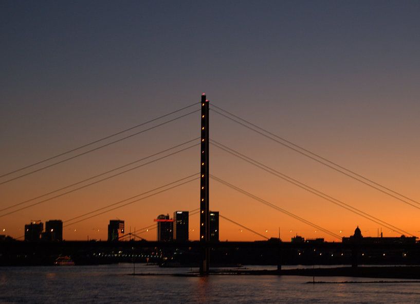 Sunset bridge in Dusseldorf by Marjolijn Vledder