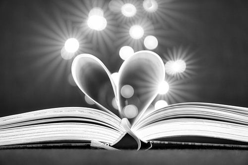 Heart pages in a book with light dots