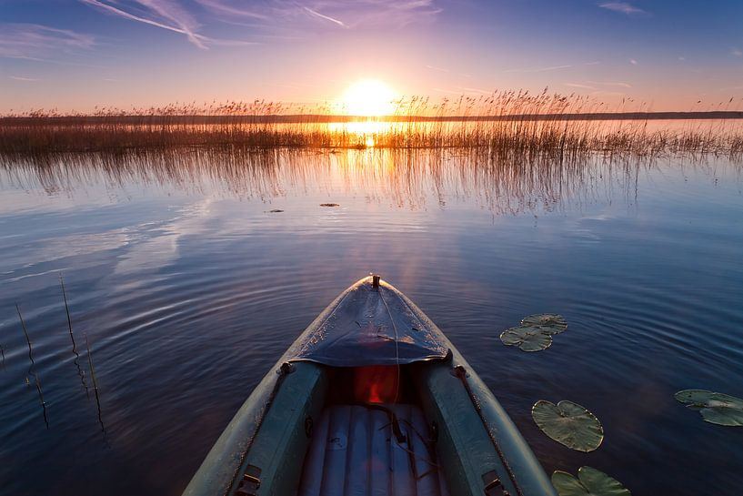 Kayak floats towards the rising sun, towards adventureSymbol of movement towards adventure. by Michael Semenov