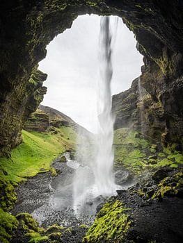 From behind the waterfall from a cave