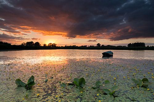 A dramatic sunset on a small lake in the Ooijpolder near Nijmeg