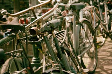 Fietsen tegen de leuning op een brug van Jos van Ooij