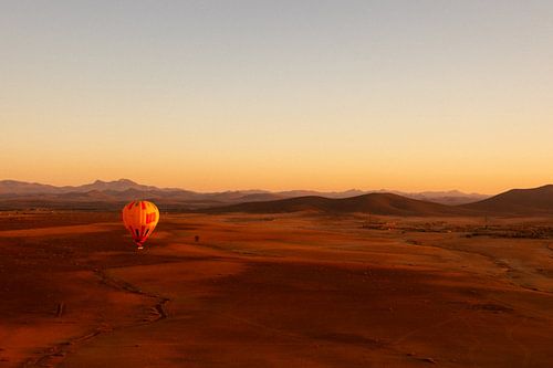 Hot air balloon floats over Moroccan desert