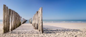 Beach poles with shade and a calm sea on Zeeland beach
