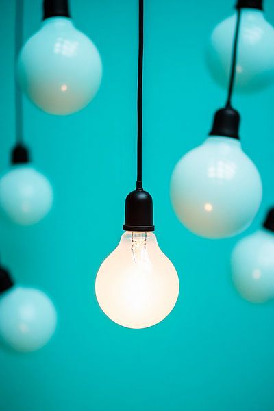 Hanging light bulbs against a blue background by Poster Art Shop
