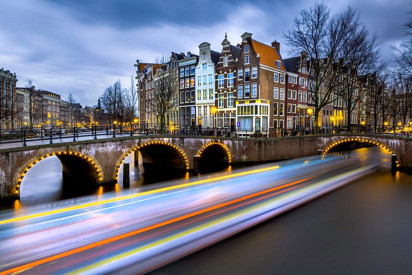 Canal boats through Amsterdam by Roy Poots