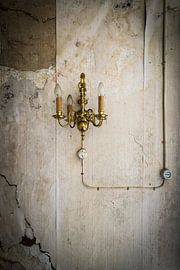 Old lamp on wall by Inge van den Brande