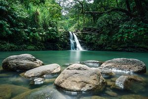 Waterfall Hawaii with rocks by road to aloha