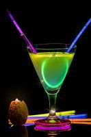 Cocktail with neon lights and candlelight