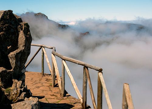 walkway with wooden railings at a great height at mountains at madeira island called pico arieiro, t