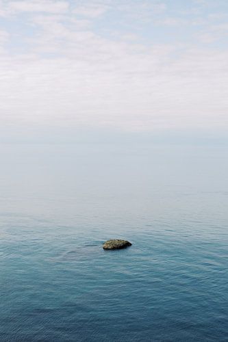 Rock in the sea | Calm infinite ocean photo wall art by Milou van Ham
