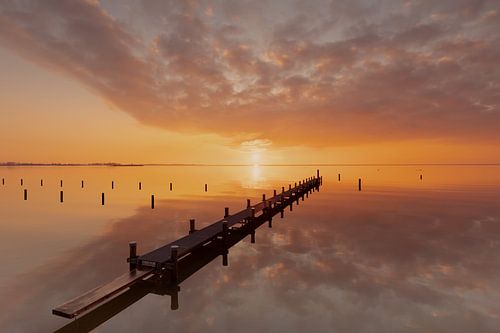 Jetty in the water at sunset