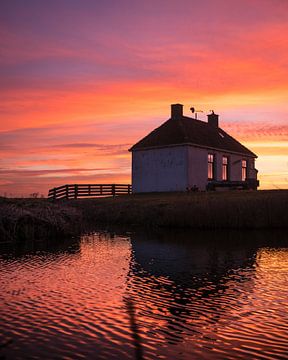 White dyke house at colourful sunset by Ewold Kooistra