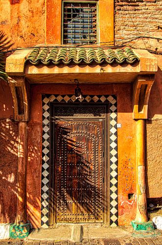 Facade with old brown entrance door in Medina of Marrakech in Morocco by Dieter Walther