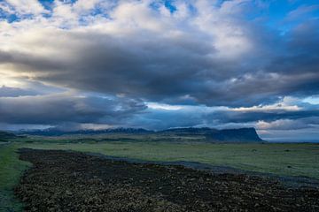 Iceland - Colorful clouds over amazing landscape and lava stones by adventure-photos