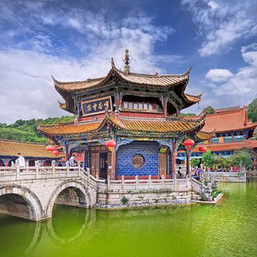 Yuantong Temple against a blue sky with dramatic clouds by Tony Vingerhoets