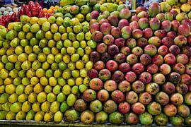 A huge pile of ripe mangoes at the market by Frank Photos