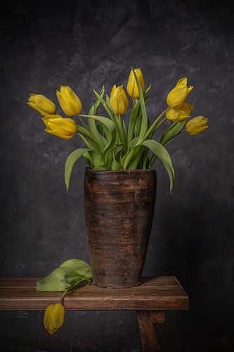 Still life of a bunch of yellow tulips in a vase