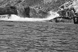 Norway by the fjord, spray on the rocks. Water splashes against the stones. Coastal landscape. by Martin Köbsch