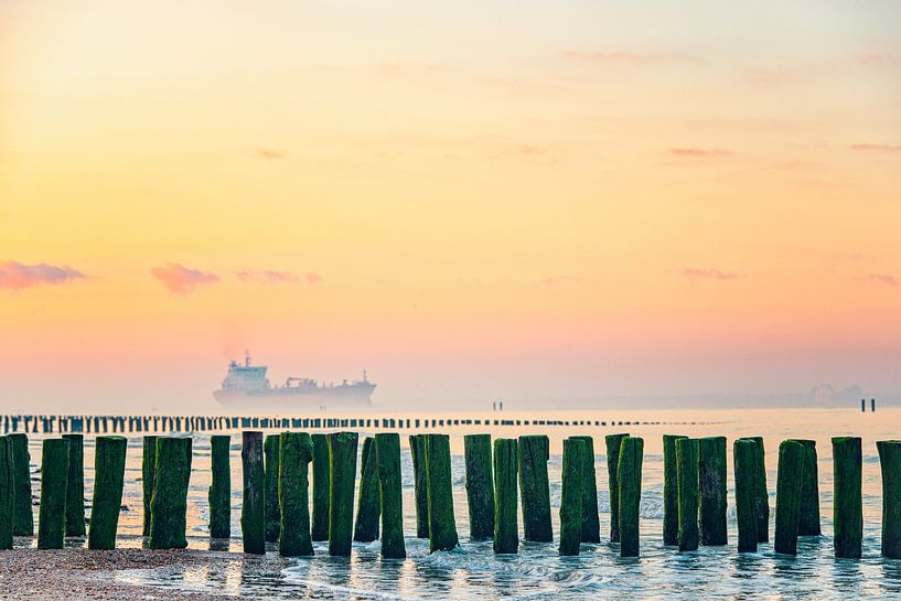 Sunrise in Zeeland with passing ship. by Ron van der Stappen