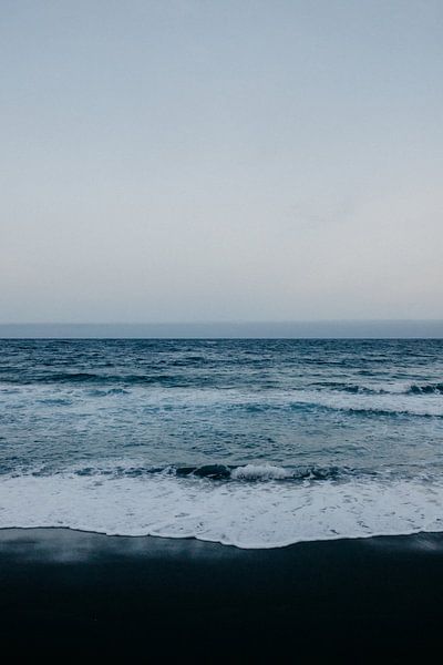 Black beach, blue sea and white waves in Tenerife by Yvette Baur