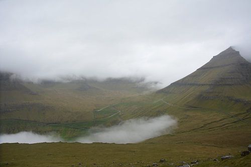 Eine kurvenreiche Straße durch den färöischen Nebel