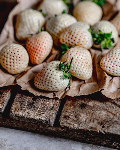 White strawberries on a wooden board from Myanmar