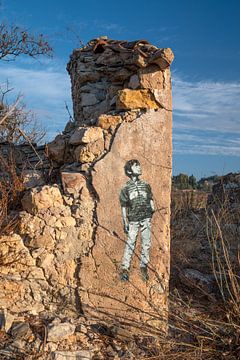 muurtekening van jongen op een ruïne in Portugal Algarve van Nienke Planken