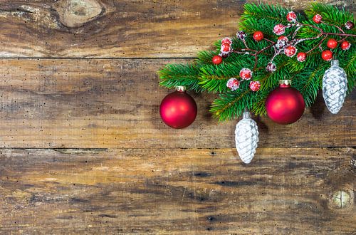 Christmas fir decoration with red berries and pine cone ornaments