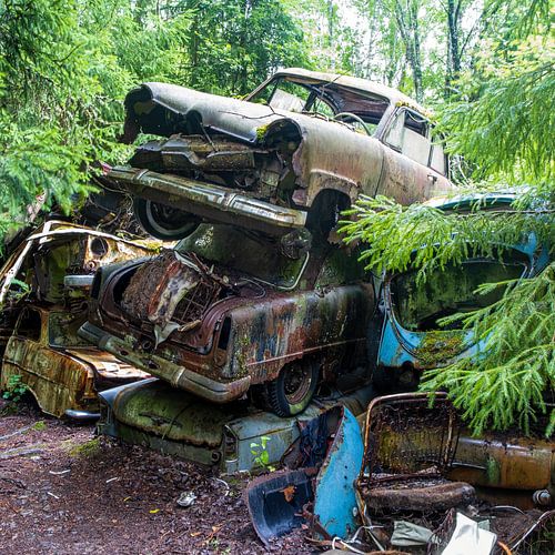 Stacked car wrecks in the forest near Bastnas in Sweden