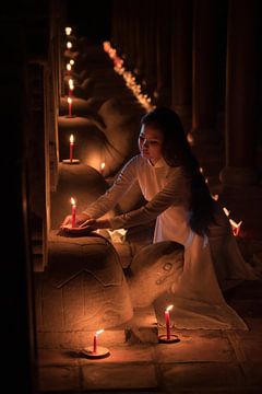 Lighting candles for the departed by Anges van der Logt