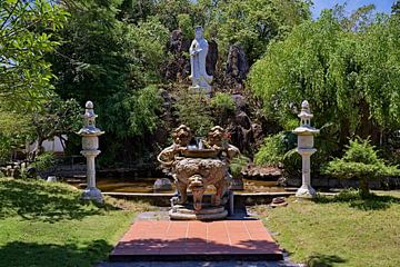 Buddhist divinity in a sacred garden by Frank Photos
