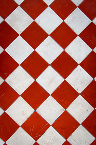 Red and white tiled floor with stains