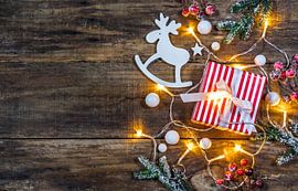 Christmas gift box with decoration and festive light by Alex Winter