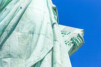 Detail of the Lady Liberty statue, book with the date of USA's independence