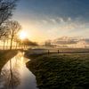 Sun coming over a typical Dutch landscape by Rene Siebring