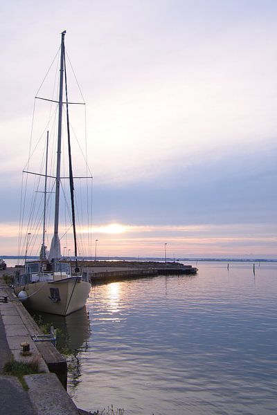 Sailing boat in the harbour at sunset by Martin Köbsch