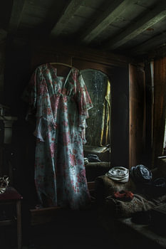 Spooky room with an spooky dress hanging in the room!