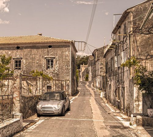 Shiny Mini Cooper in old Greek village