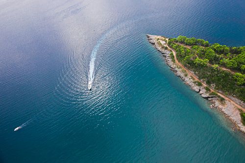 Forest peninsula and motor yachts sail. landscape below (aerial photo from a paraglider) with the co