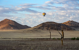 Landscape in Africa with a beautiful sky and a hot-air balloon