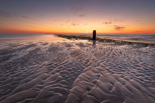Beach at Sint Maartenszee - Sunset with pole in the surf