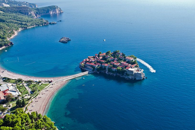 Flight over the island city (Sveti Stefan). landscape below (aerial photo from a paraglider) with th by Michael Semenov