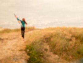 Freedom;Redheaded girl with kite in the dunes by Elke van Hessem