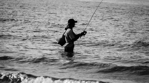 Fisherman in the sea B/W