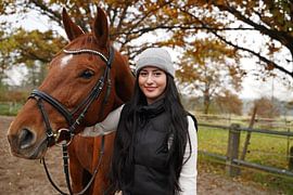 Training with the bay Oldenburg mare on a riding arena