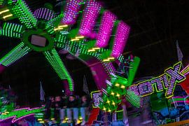 Spinning Energy – a fairground ride bathed in the colourful lights of the night by Mixed media vector arts