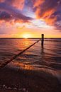 they sink (kleurrijke zonsondergang strand Domburg) van Thom Brouwer thumbnail